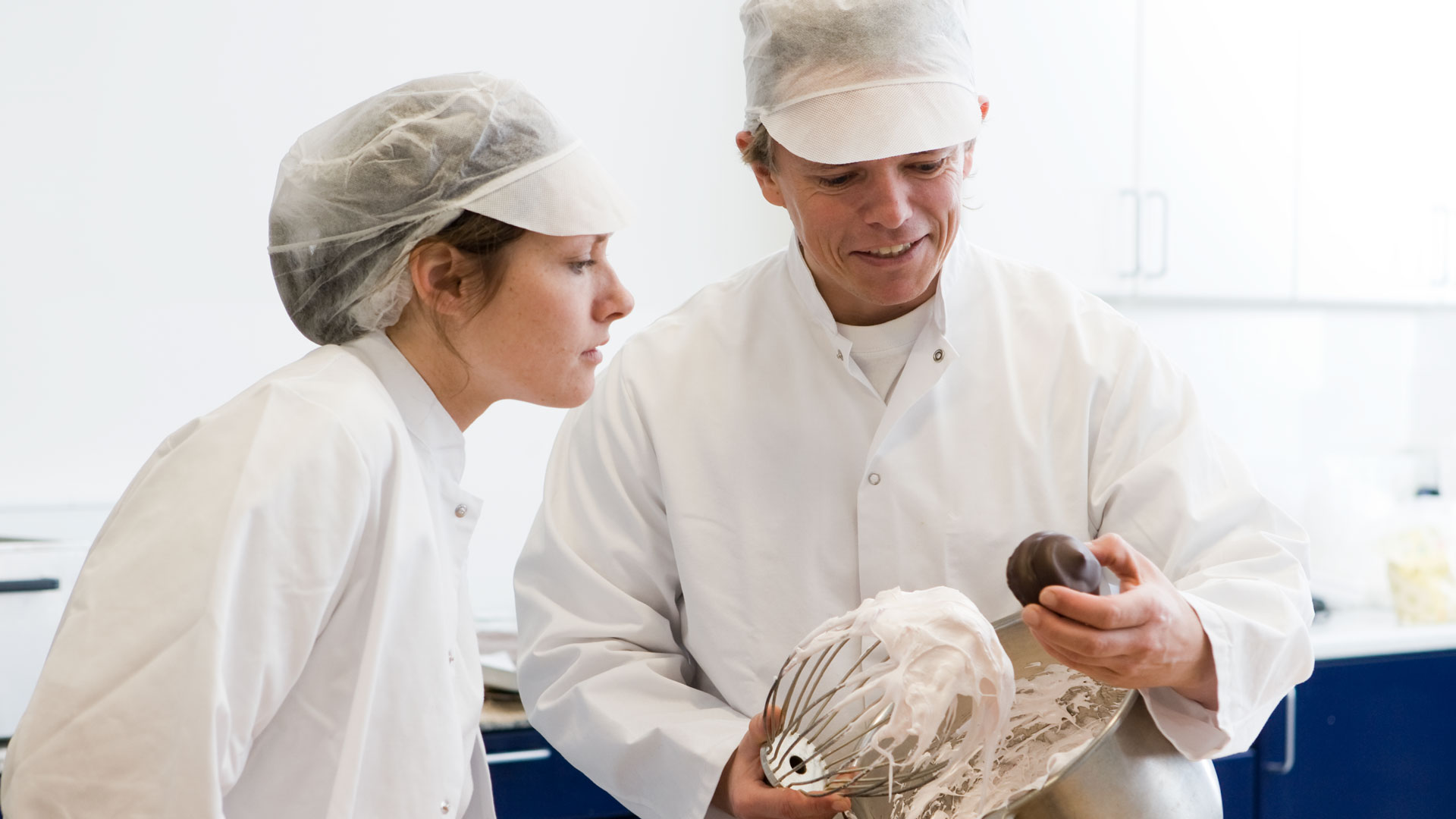 Food technologists evaluating enzyme functionality in egg-based product development.