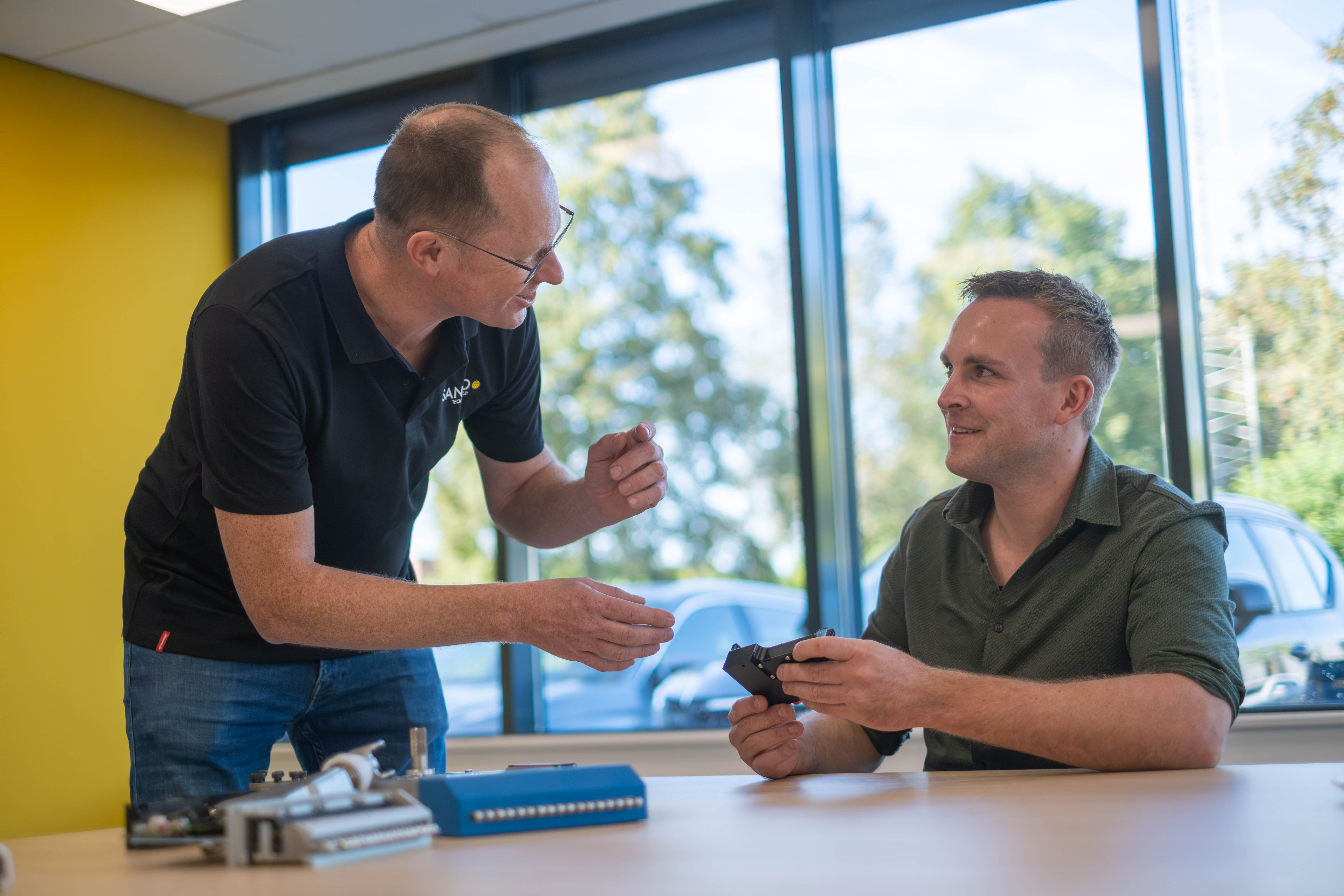 SANOVO specialist discussing grading equipment with a customer.