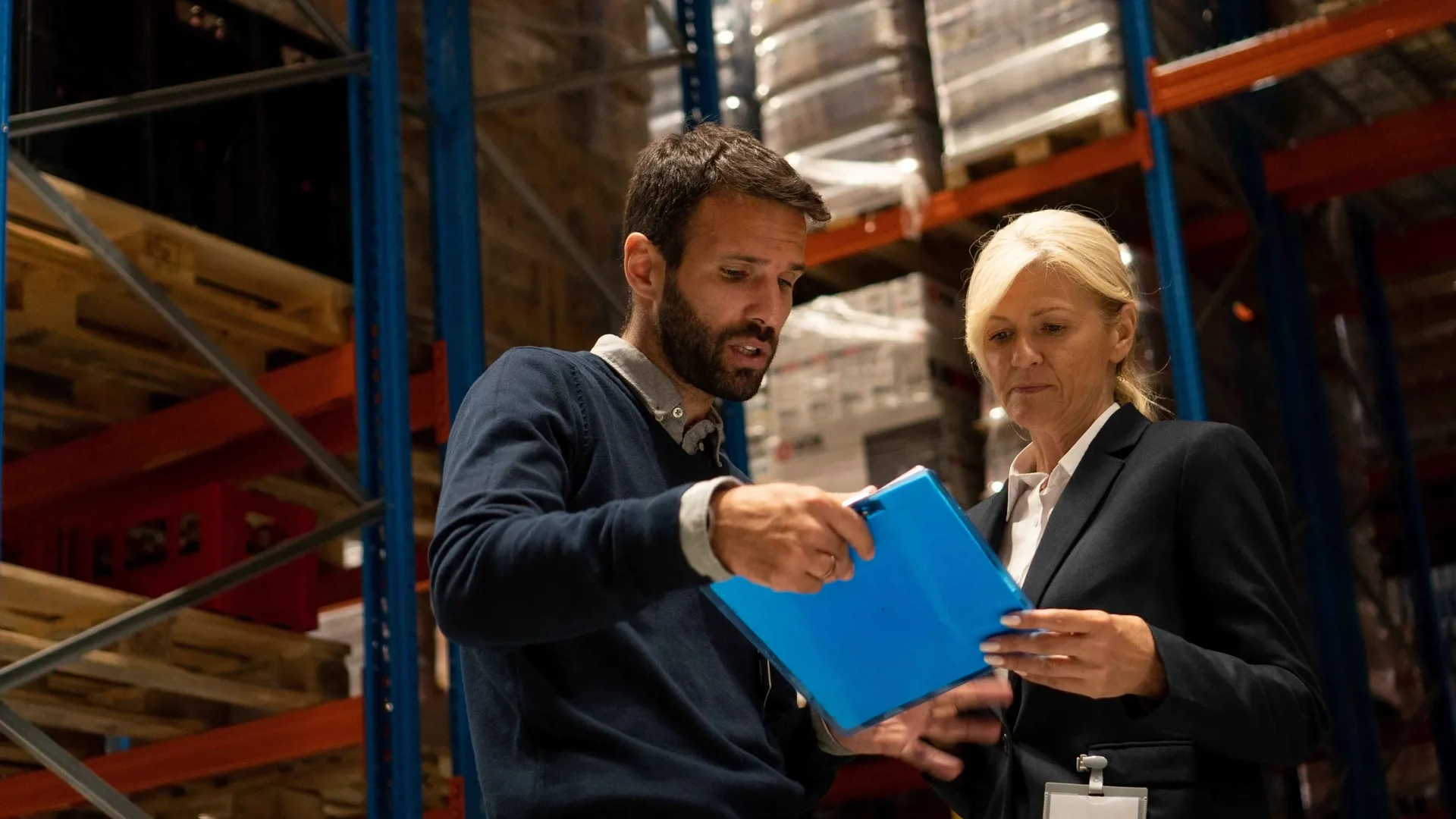 Two people reviewing a clipboard in a warehouse