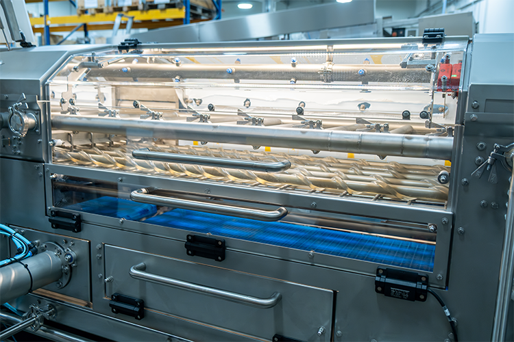 Close-up of SANOVO Cook2Peel Pro Peeler showing transparent peeling chamber and rollers.