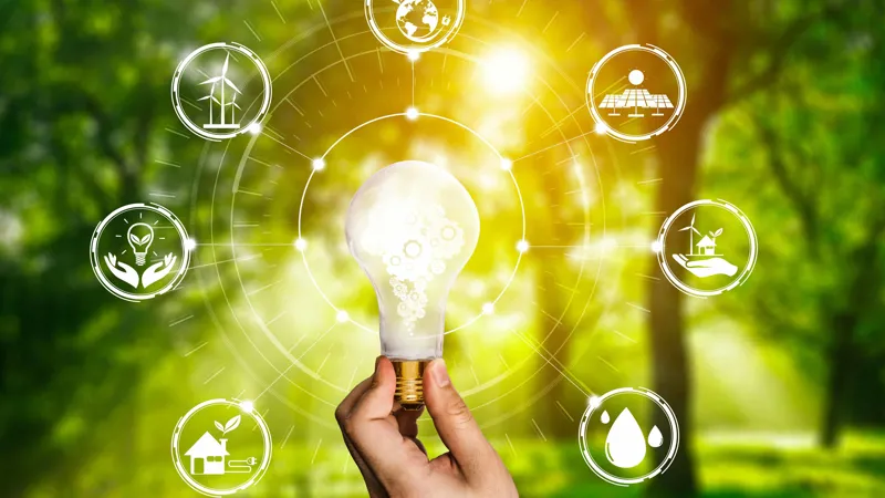 Symbolic image of sustainability and renewable energy with lightbulb and eco icons