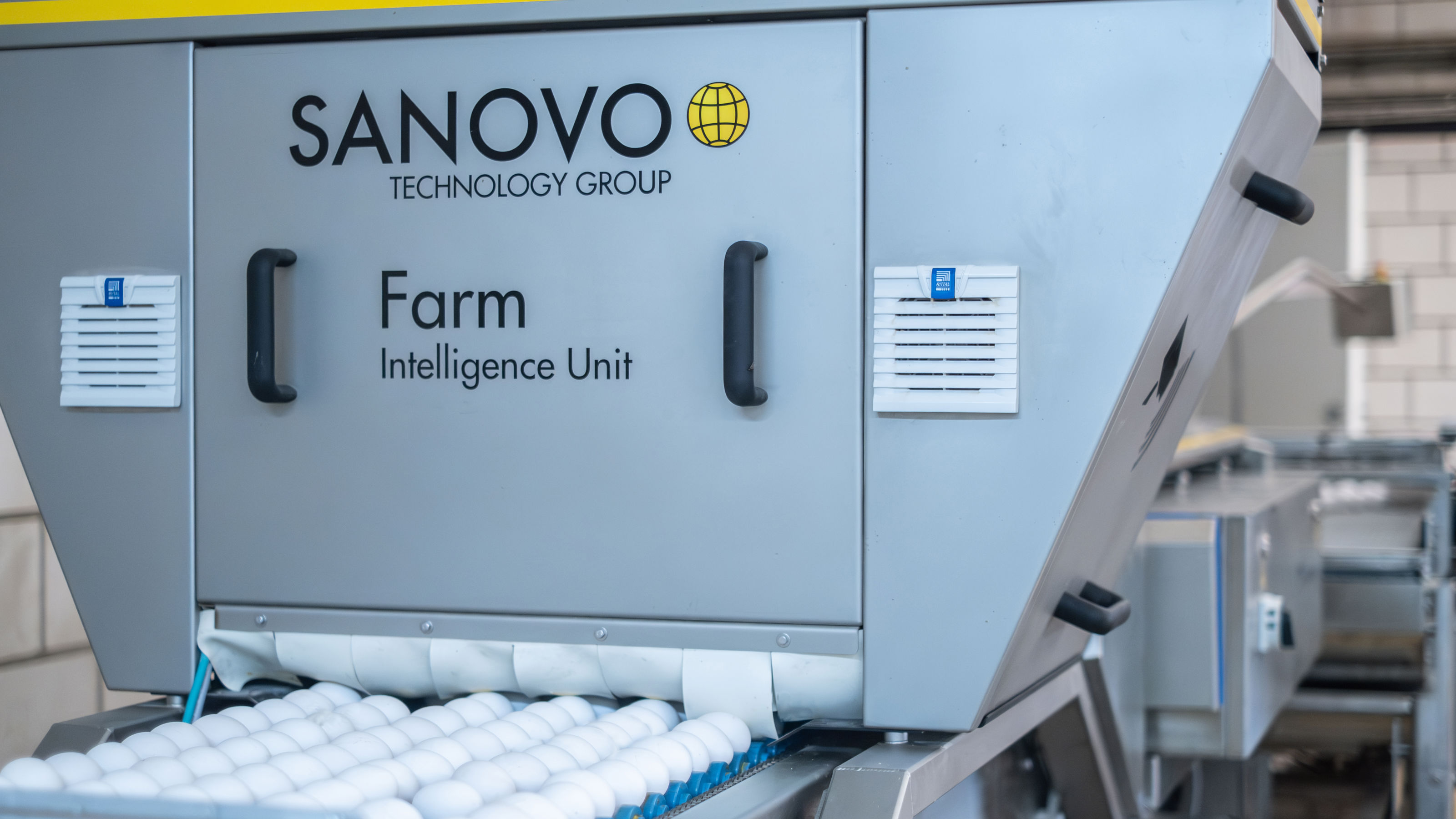 Front view of the SANOVO Farm Intelligence Unit inspecting eggs on a conveyor belt