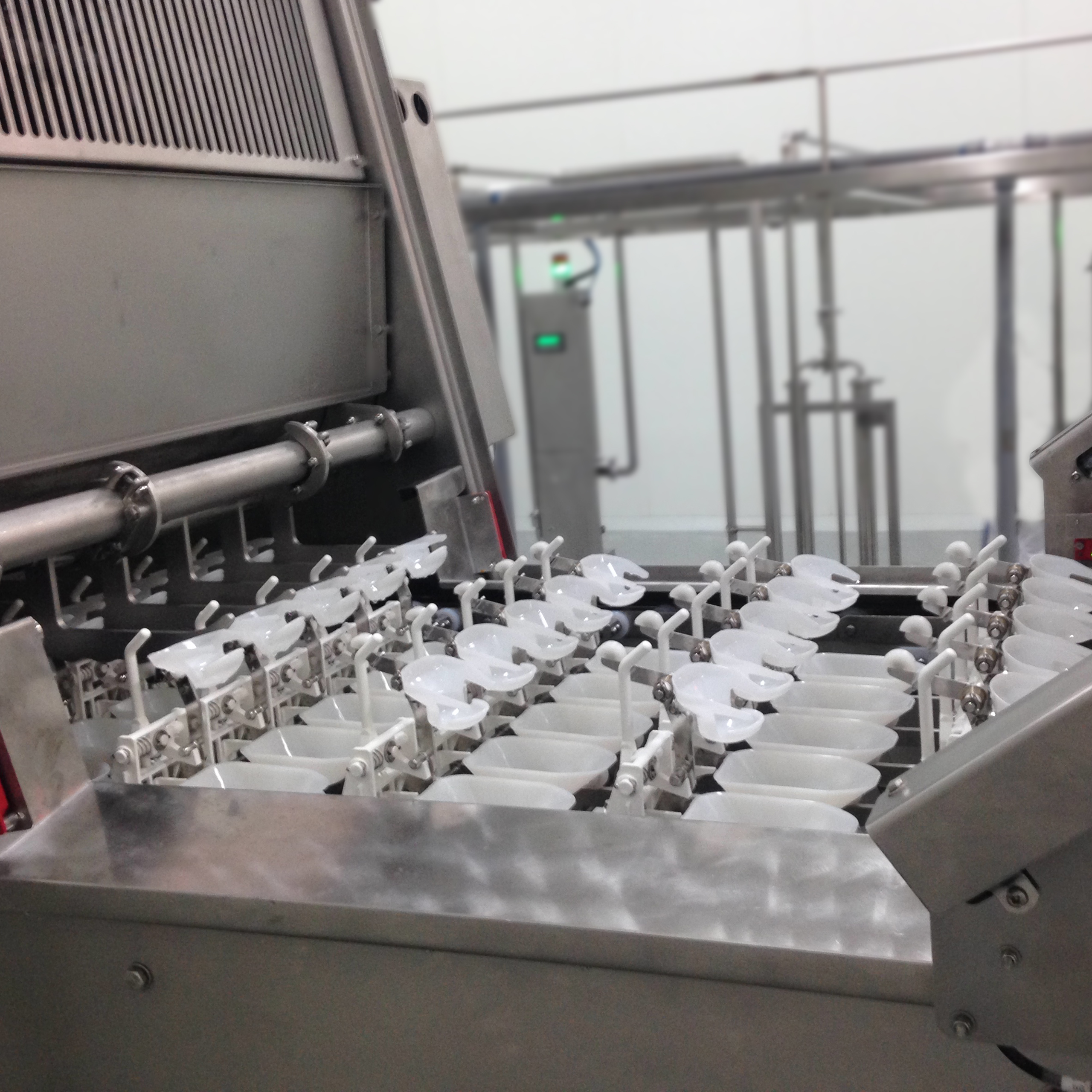 Egg breaking and separating cups inside a SANOVO OptiBreaker egg breaking machine.