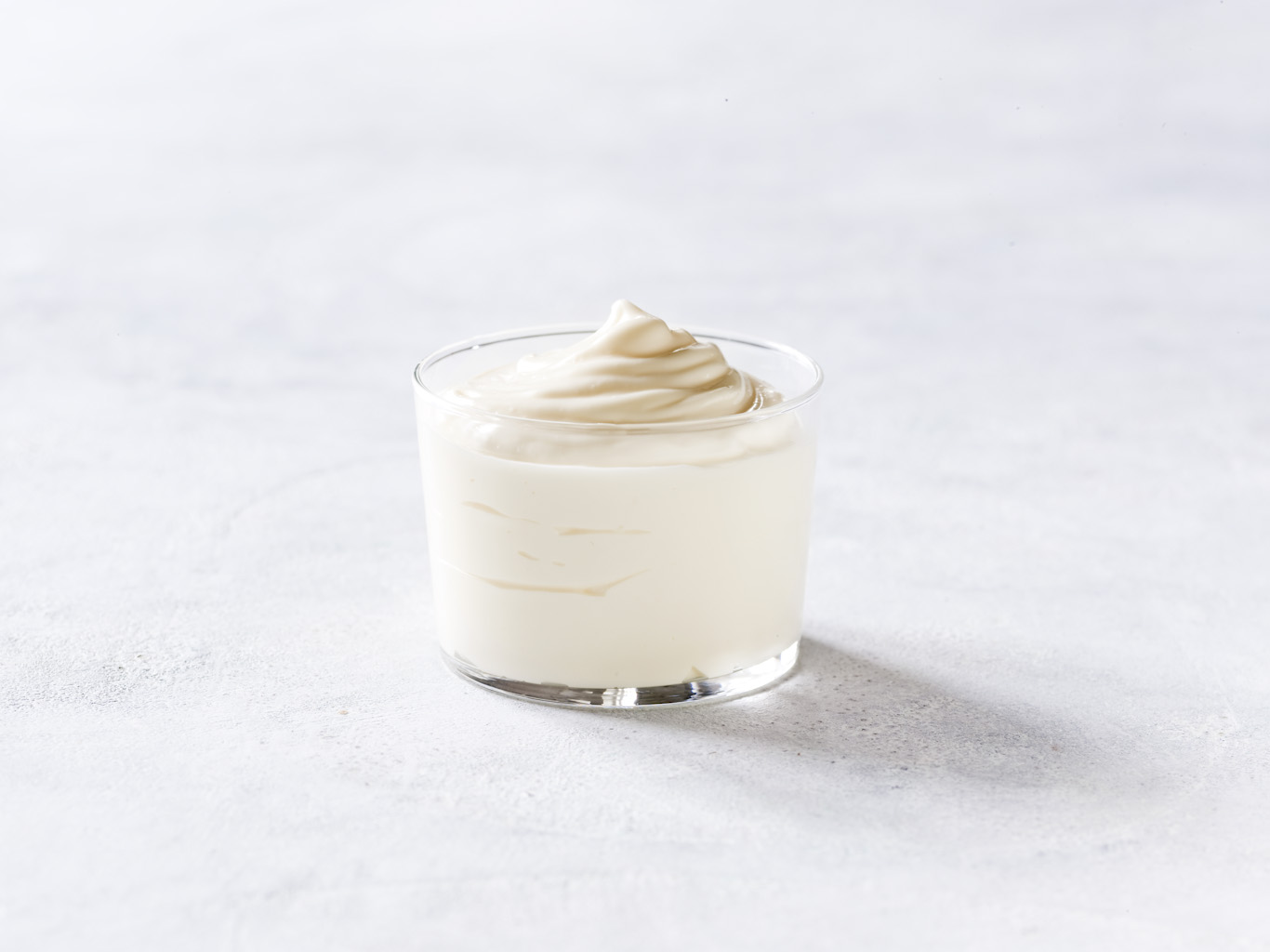 Mayonnaise in a glass bowl symbolizing functional ingredients for egg processing, offered by SANOVO PROCESS SOLUTIONS.