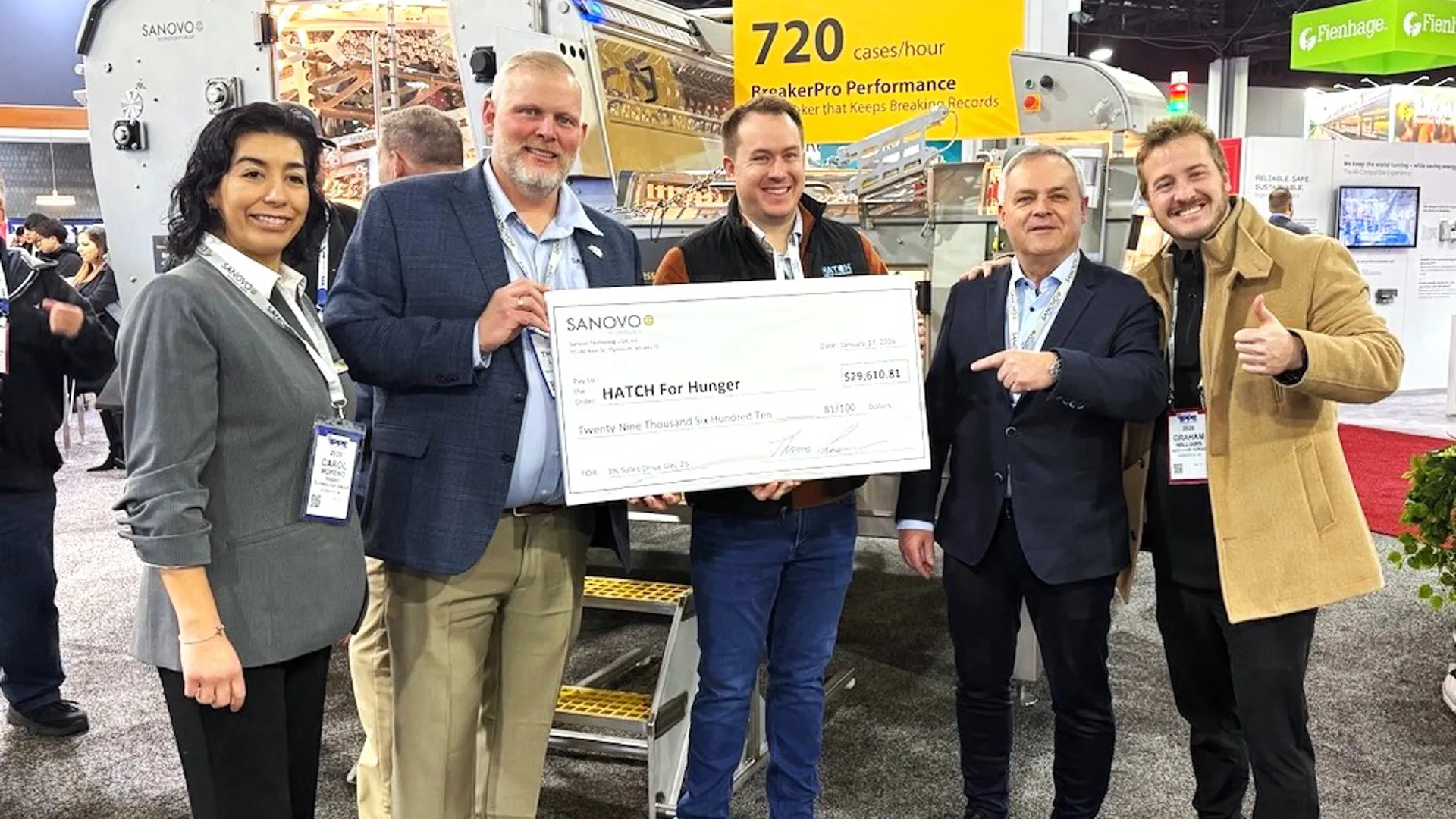 SANOVO TECHNOLOGY GROUP team holding a donation check of 29,610 USD for the Hatch for Hunger organization.
