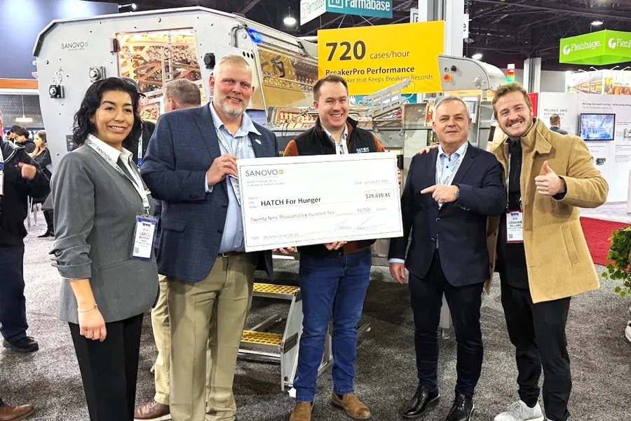 SANOVO TECHNOLOGY GROUP team holding a donation check of 29,610 USD for the Hatch for Hunger organization.