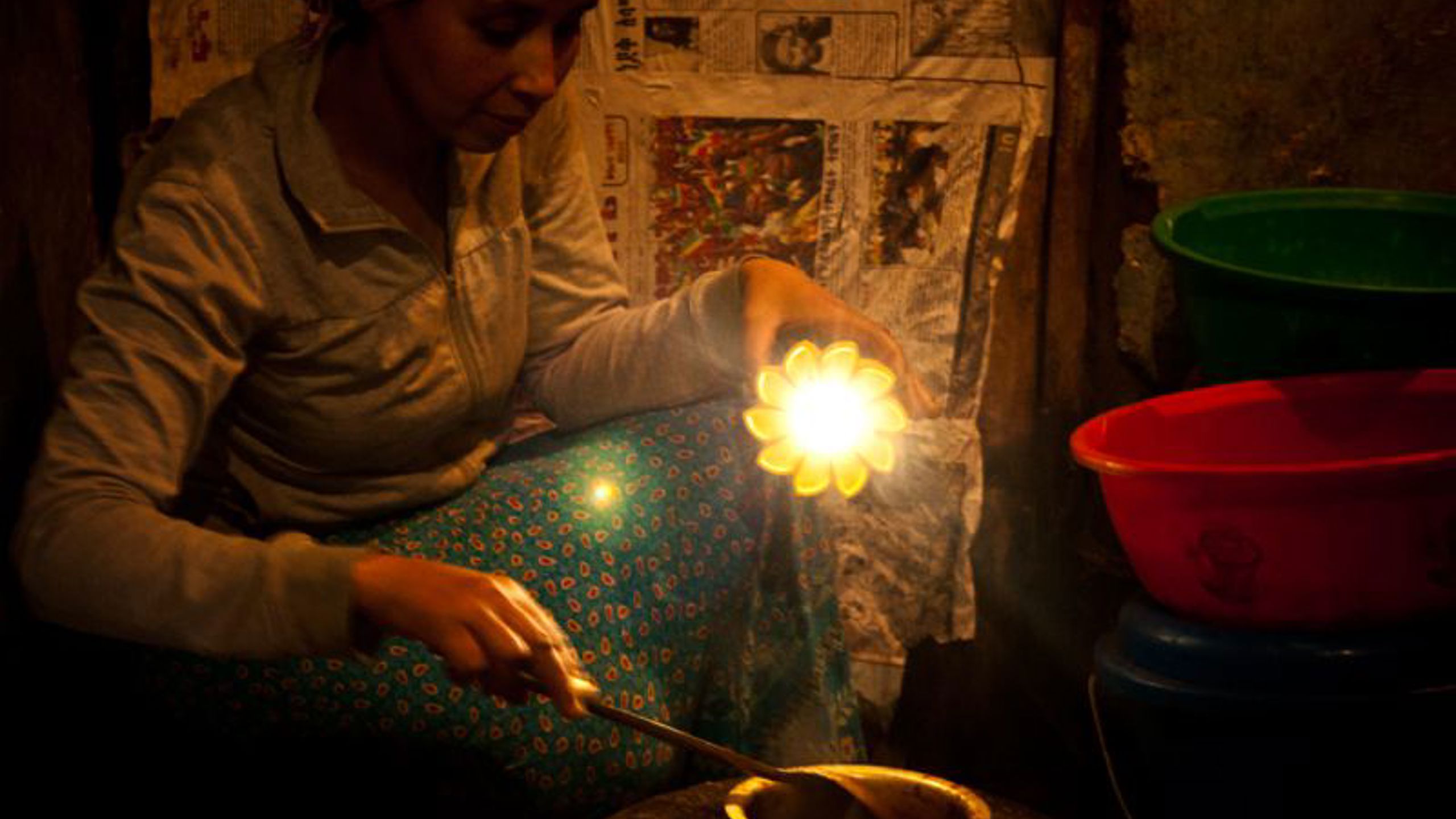 Woman cooking with support of donated solar light