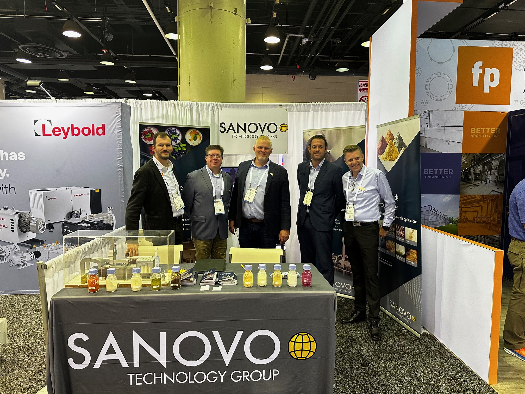 SANOVO TECHNOLOGY PROCESS team showcasing food and ingredient processing solutions at a trade show.