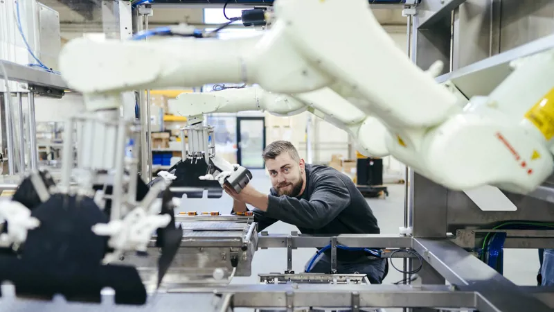 SANOVO production worker working with robotic machinery