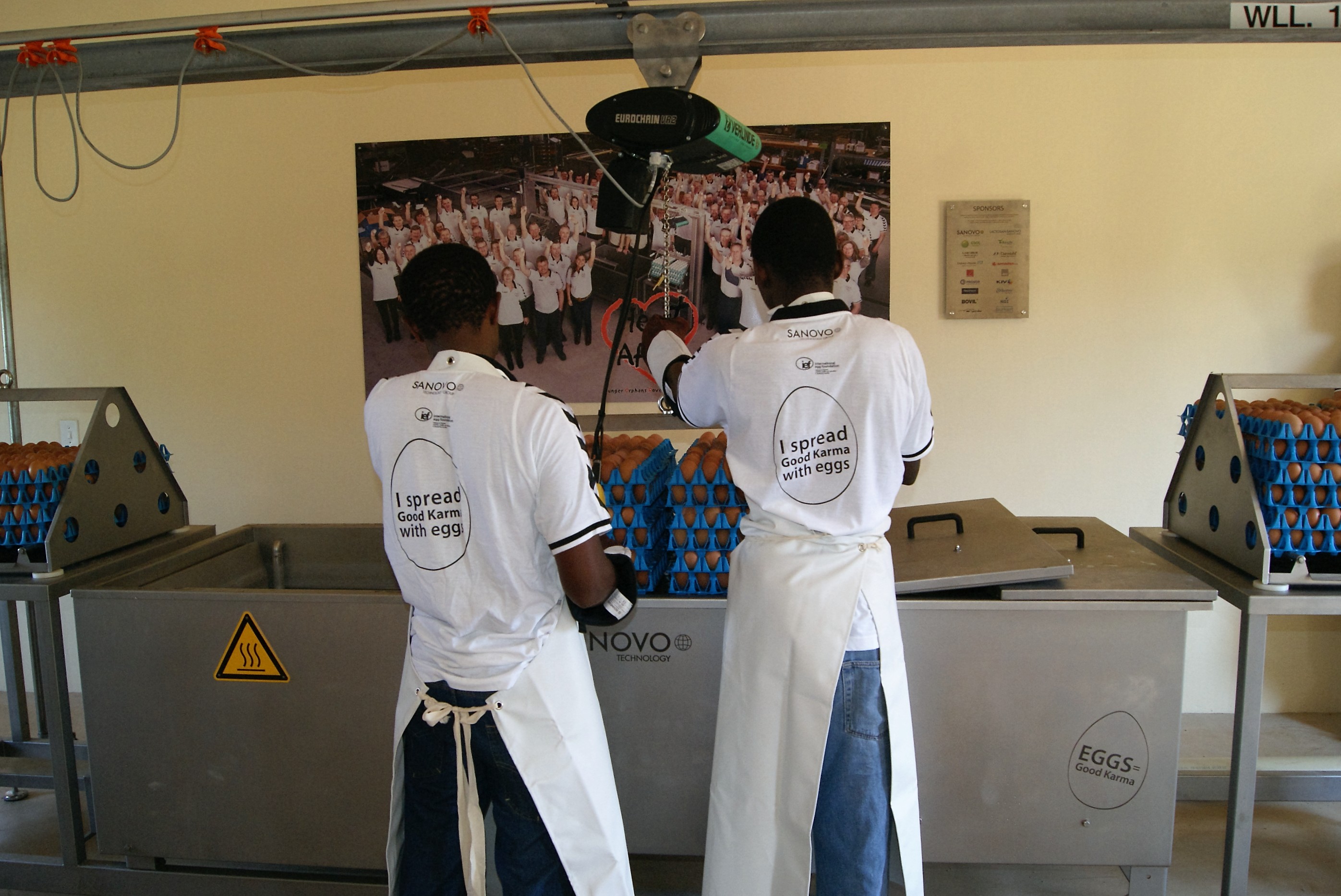 Heart for Africa team working with SANOVO egg boiler machine.