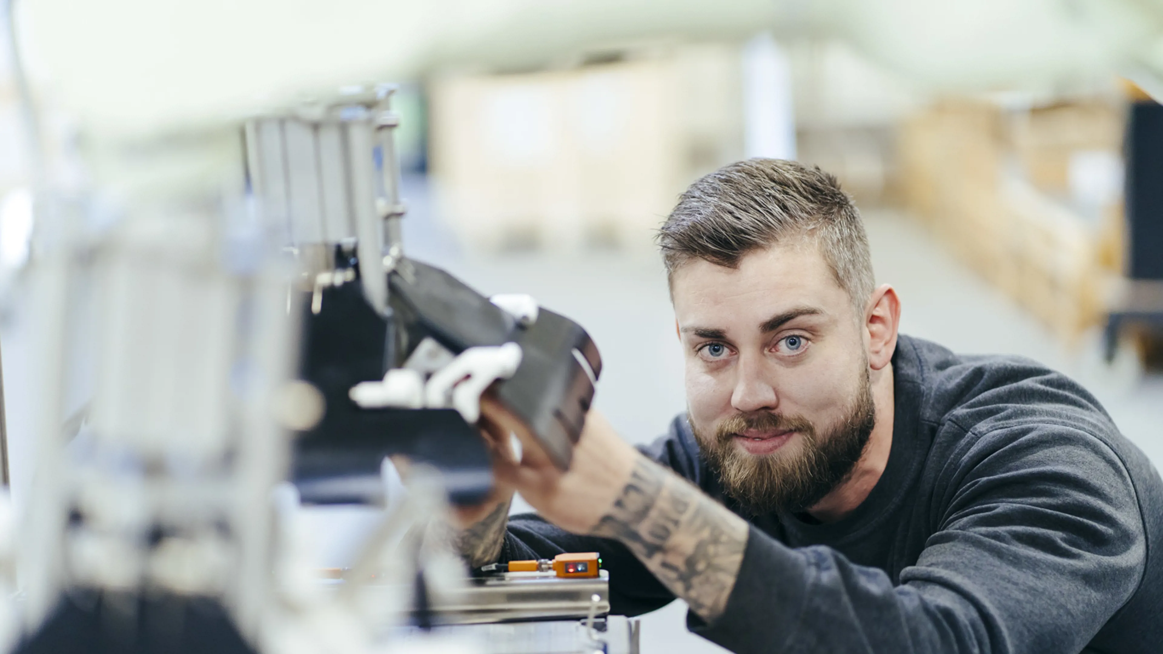 Technician inspecting machinery components at SANOVO
