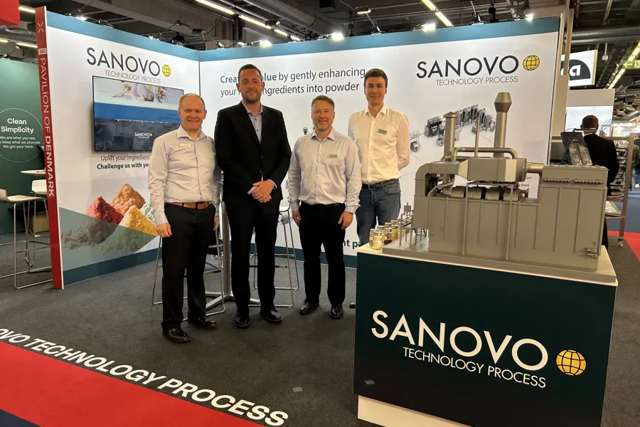 SANOVO TECHNOLOGY PROCESS team at a trade show booth presenting spray drying and powder processing solutions.