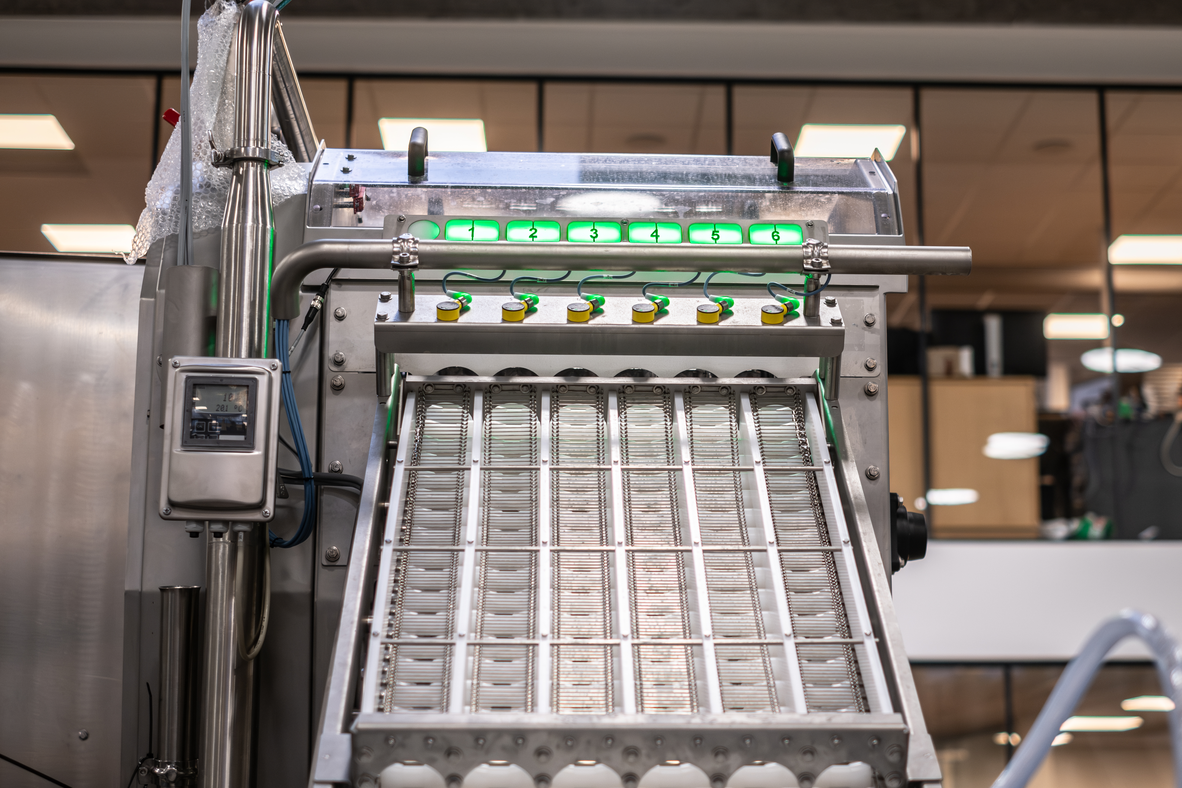 Close up of the infeed on the SANOVO BreakerPro 6 egg breaker machine.