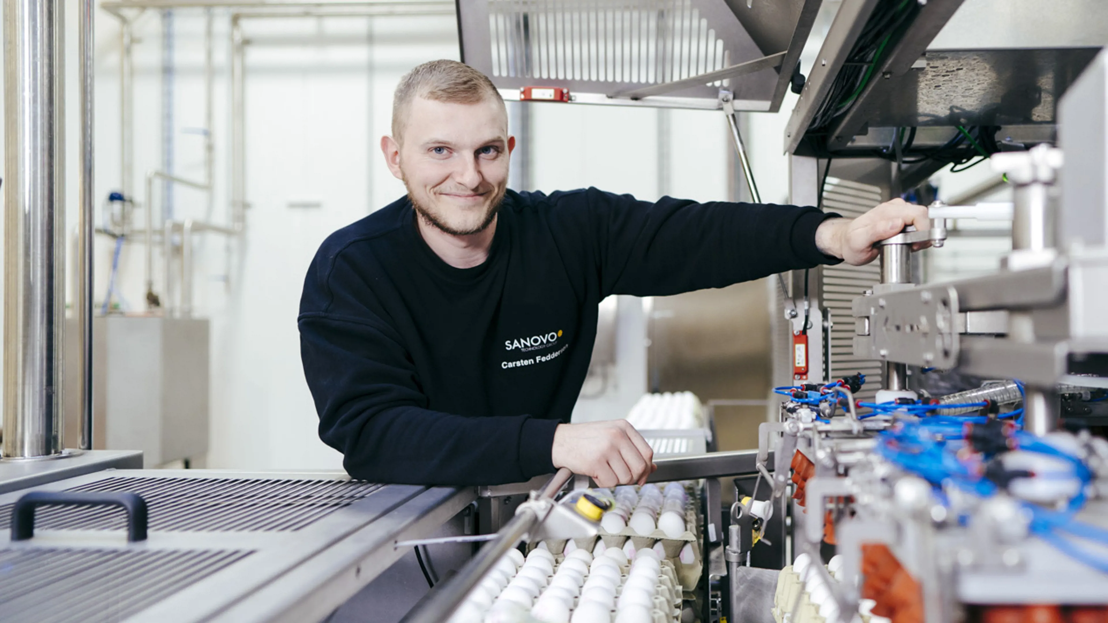 Service technician standing next to SANOVO equipment.