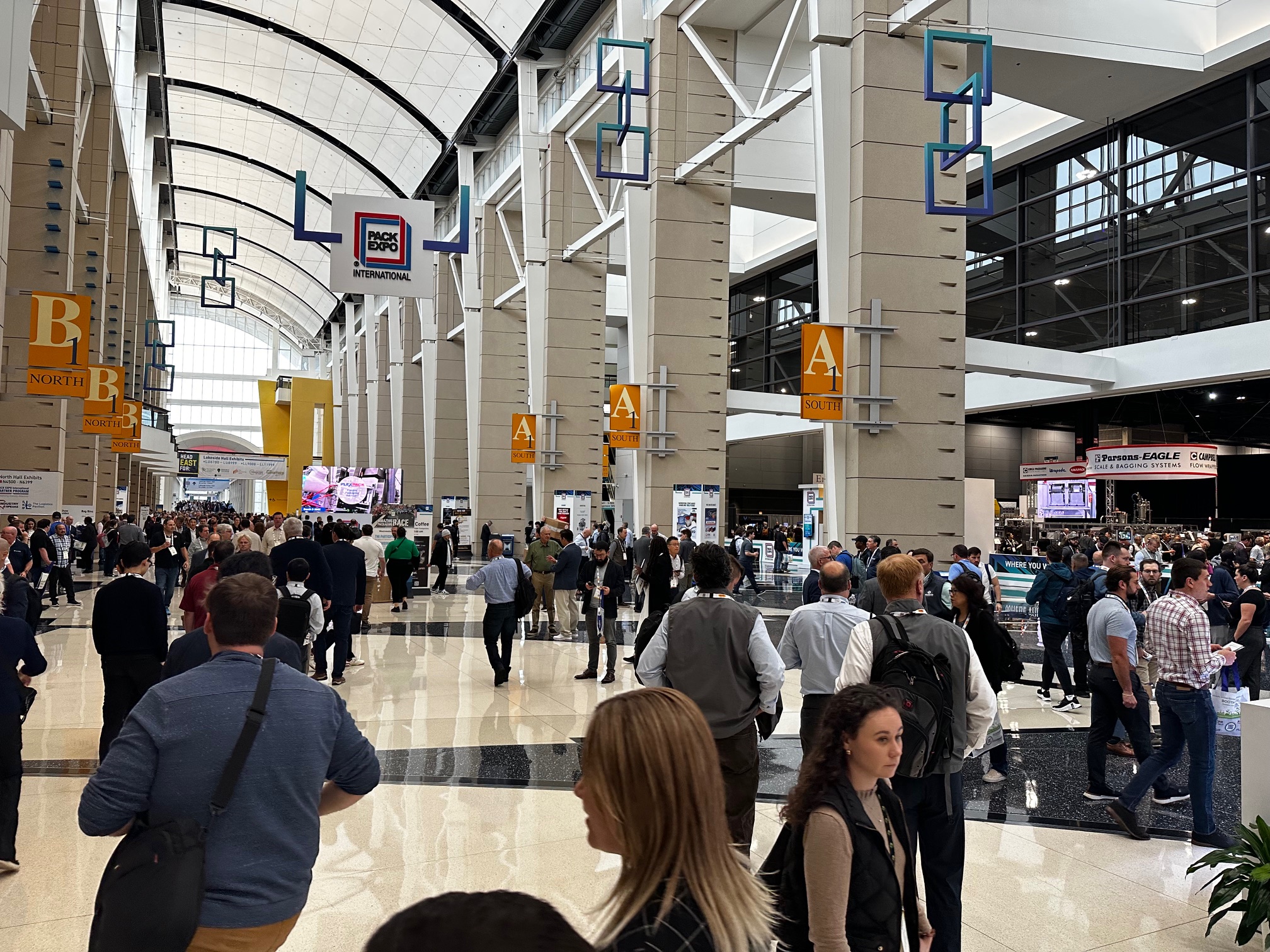 Busy exhibition hall during an international food and processing industry trade show.