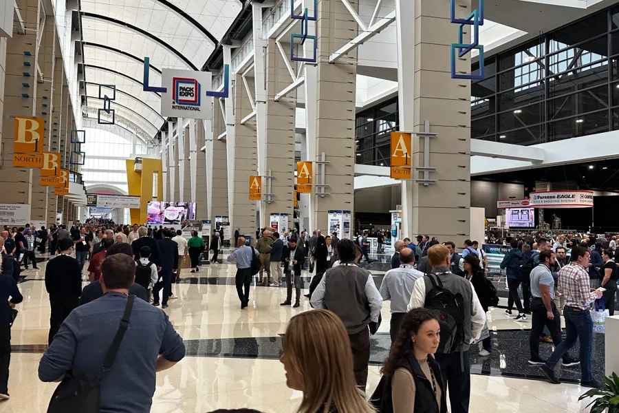 Busy exhibition hall during an international food and processing industry trade show.