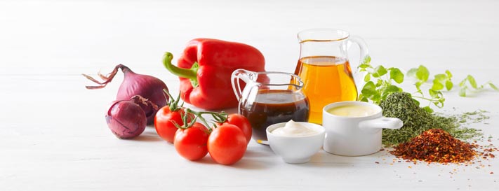 Fresh vegetables, herbs, and sauces symbolizing allergen-free applications of Delvo™Nis preservative, offered by SANOVO PROCESS SOLUTIONS for liquid egg products.