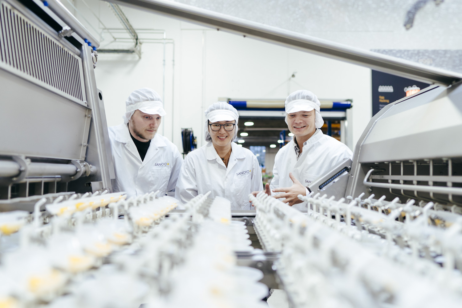 Team inspecting a SANOVO egg breaker machine