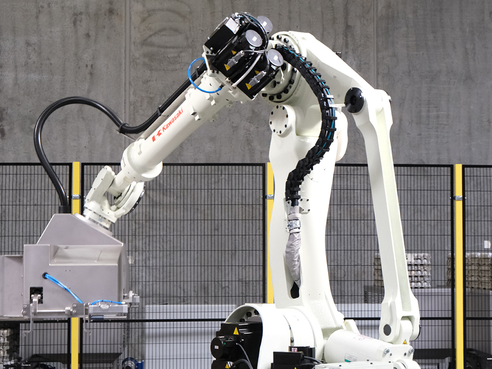 Robotic egg palletizer arm positioning the SANOVO lifting head for automated egg tray handling.