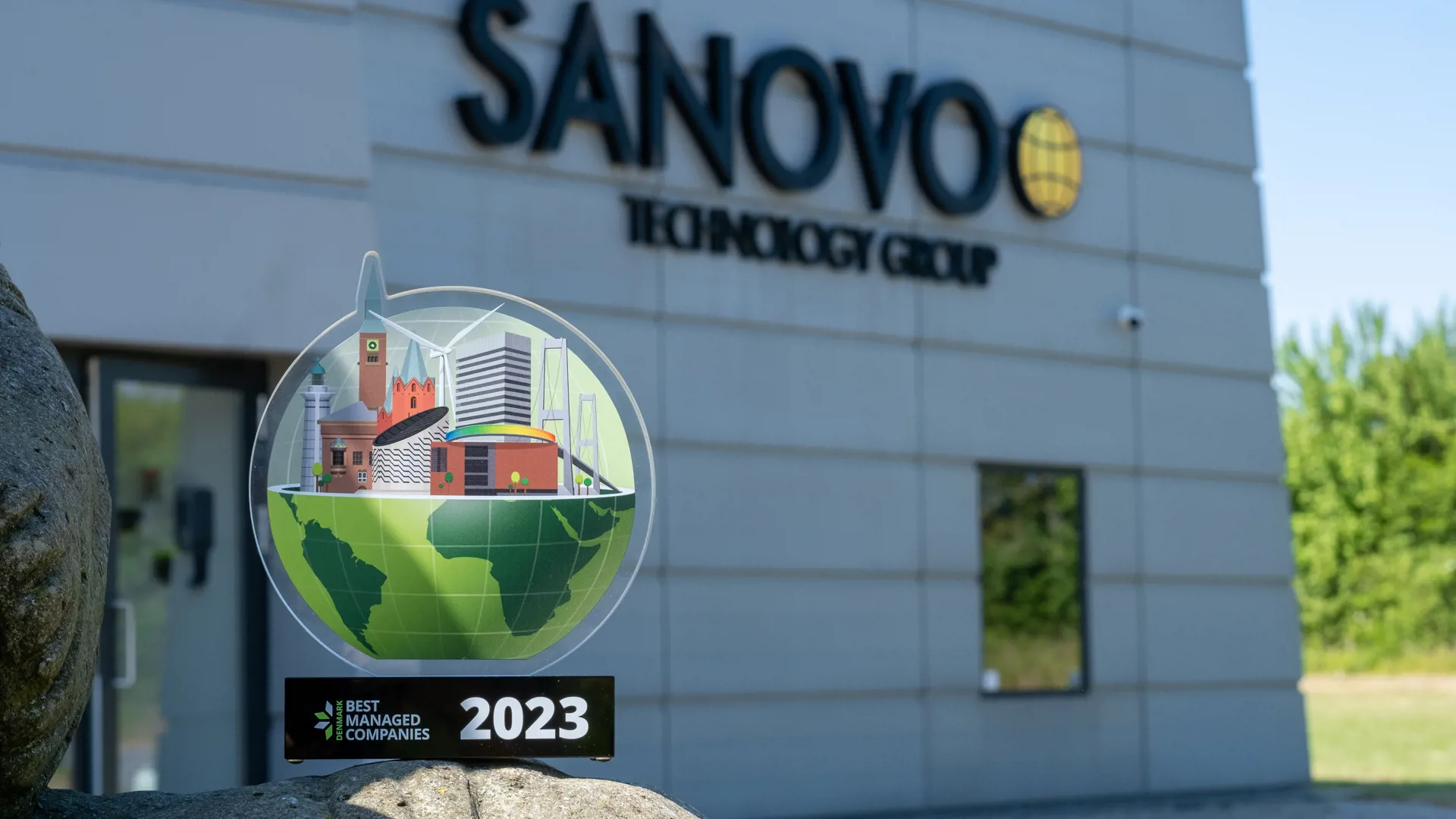 Best Managed Companies 2023 Trophy in front of the SANOVO TECHNOLOGY GROUP headquarters.
