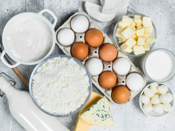 Dairy products and eggs arranged on a white surface for food ingredient applications