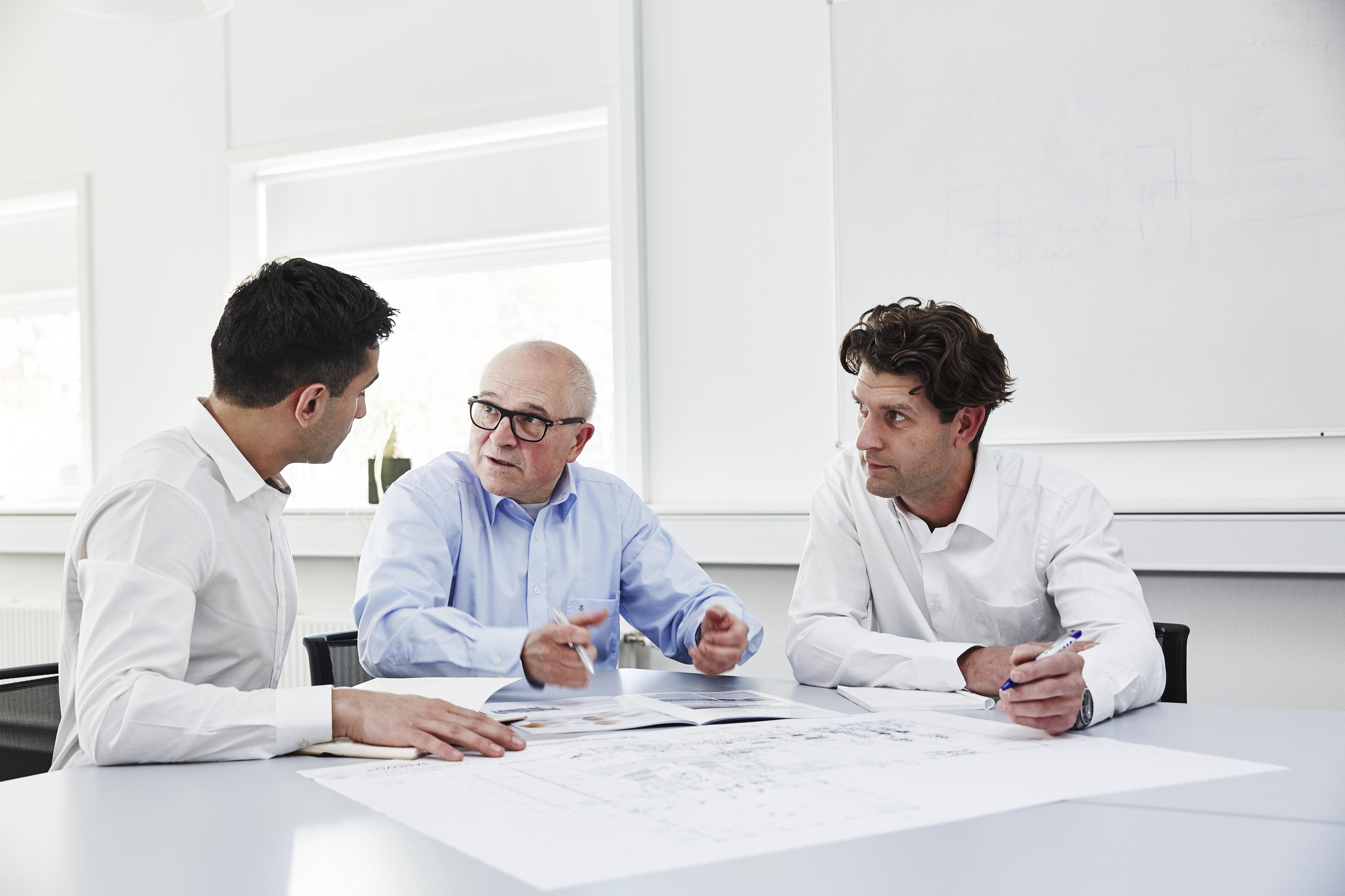 3 men discussion a sales project at SANOVO