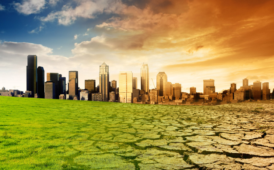 Symbolic image of climate change showing contrast between healthy green land and drought-stricken soil