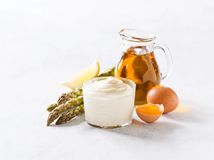 Mayonnaise with egg yolk, oil, and vegetables symbolizing heat-stable emulsions produced with MAXAPAL™A2 enzyme, offered by SANOVO PROCESS SOLUTIONS.