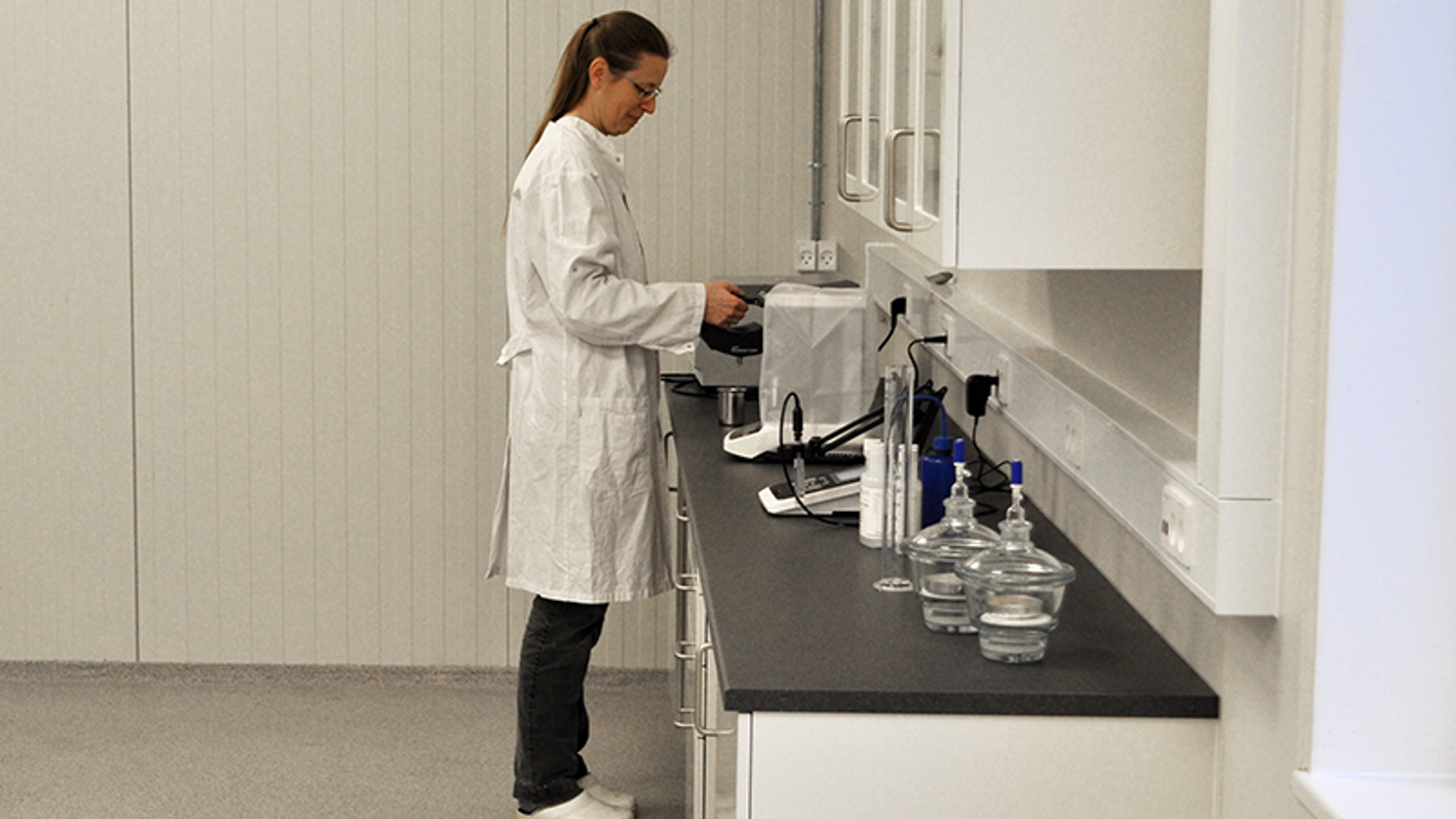 Technician in a lab working with food powder processing equipment.