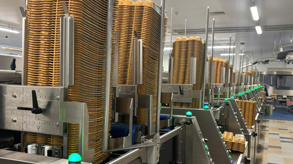 Stacks of egg trays stored in automated tray handling system inside Greenfield egg grading facility.