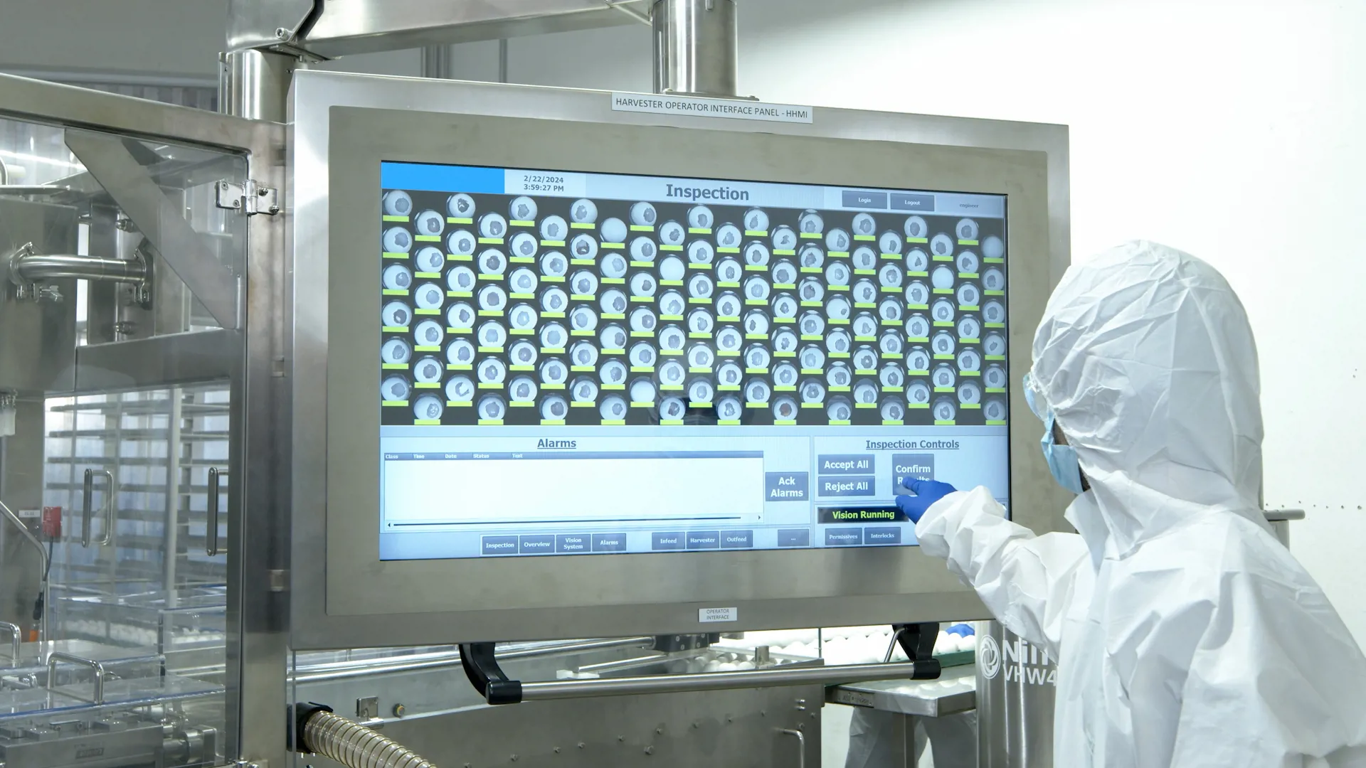 Technician using the SANOVO Automatic Harvester touchscreen to inspect viable eggs.